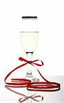 The Beautiful crystal goblet with wine. Drumstick of the goblet decorated red tape