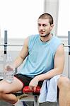 young man drinking water at fitness workout training at sport club