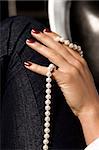 women hand with white pearls