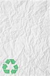 texture of white crumpled paper and green recycling sign