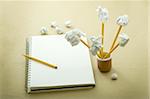 flower made of crumpled paper, notebook and pencil