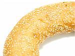 A part of a bagel with sesame seeds on the white background