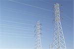 High voltage power lines over blue sky