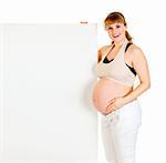 Smiling beautiful pregnant woman holding blank billboard  isolated on white