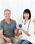 Nurse helping her patient to do exercises at home