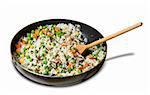 fried rice with vegetables in a skillet, isolated on white