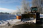 Winter heavy equipment big yellow tractor