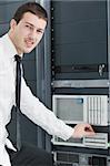 young handsome business man it  engeneer in datacenter server room