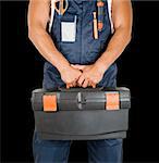 repairman with box of instruments on black background