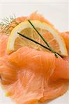 photo of delicious smoked salmon with slice of lemon and fennel