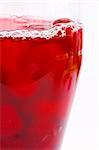 fresh red berry compote in a glass on a white background