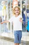 The little girl waving a bag in the store