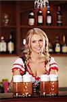 Attractive girl in a bar with beer