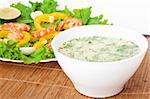 Soup with a salad on a wooden tablecloth