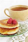 Morning breakfast pancakes with the raspberries and the tea