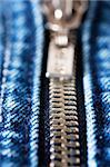 Macro shot of closed zipper on a blue jeans. Shallow depth of field