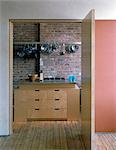 Warehouse Apartment. Door from dining area into kitchen. Architects: Ken Rorrison