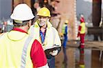 Workers talking on oil rig