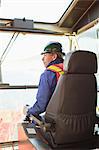 Worker operating machinery on oil rig