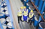 Workers with clipboards in warehouse