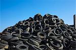 Pile of old tires under blue sky