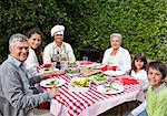 Happy family eating in the garden