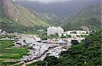 Small fishing village at a base of a high mountain,hong kong