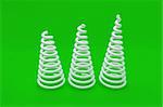 White coil spring on green background