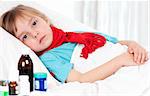 Sick little beautiful girl with red scarf in the bed