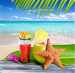 coconuts cocktails straw tropical caribbean beach with starfish