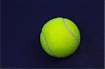 New Tennis Ball on Blue Court Surface