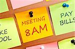 Meeting 8AM post it on wooden wall
