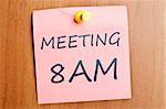 Meeting at  8AM word  post it on wooden wall