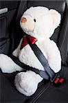 safety first concept with teddy bear in car