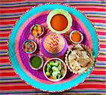 assorted Mexican sauces spices chili pico gallo on Mexican colorful hat
