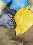 Many Garbage Plastic Bags With Different Colours Piled Up