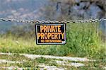 black orange white private property hanging sign