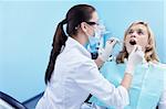 The dentist examines a patient