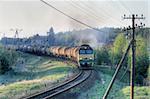 Freight train hauled by the diesel locomotive passing the station