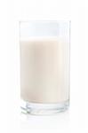 Glass of soy milk on white background