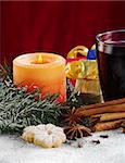 Candle and mulled wine with cookies, spices and Christmas gifts (Selective Focus, Focus on the candle and the mulled wine)