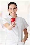 Young nurse with heart in her hand