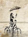 Girl with umbrella on bike. Photo in old image style.