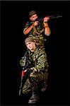 Two soldiers with weapon, isolated on black background