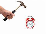 An alarm clock and a hammer isolated against a white background