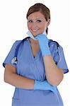 A attractive young female nurse wearing gloves and a mask, isolated on a solid white background.