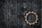 gear wheel on wooden grunge background