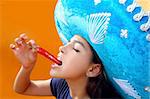 Mexican girl profile eating red hot chili pepper mexican hat