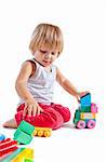 Cute little boy playing with toys, isolated on white background