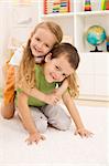 Little boy anf girl wrestling and having fun in their room